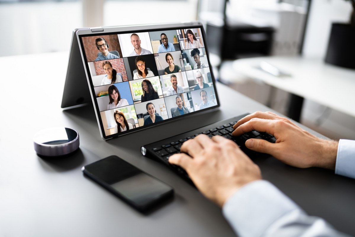 Male business owner hosts virtual meet-up.
