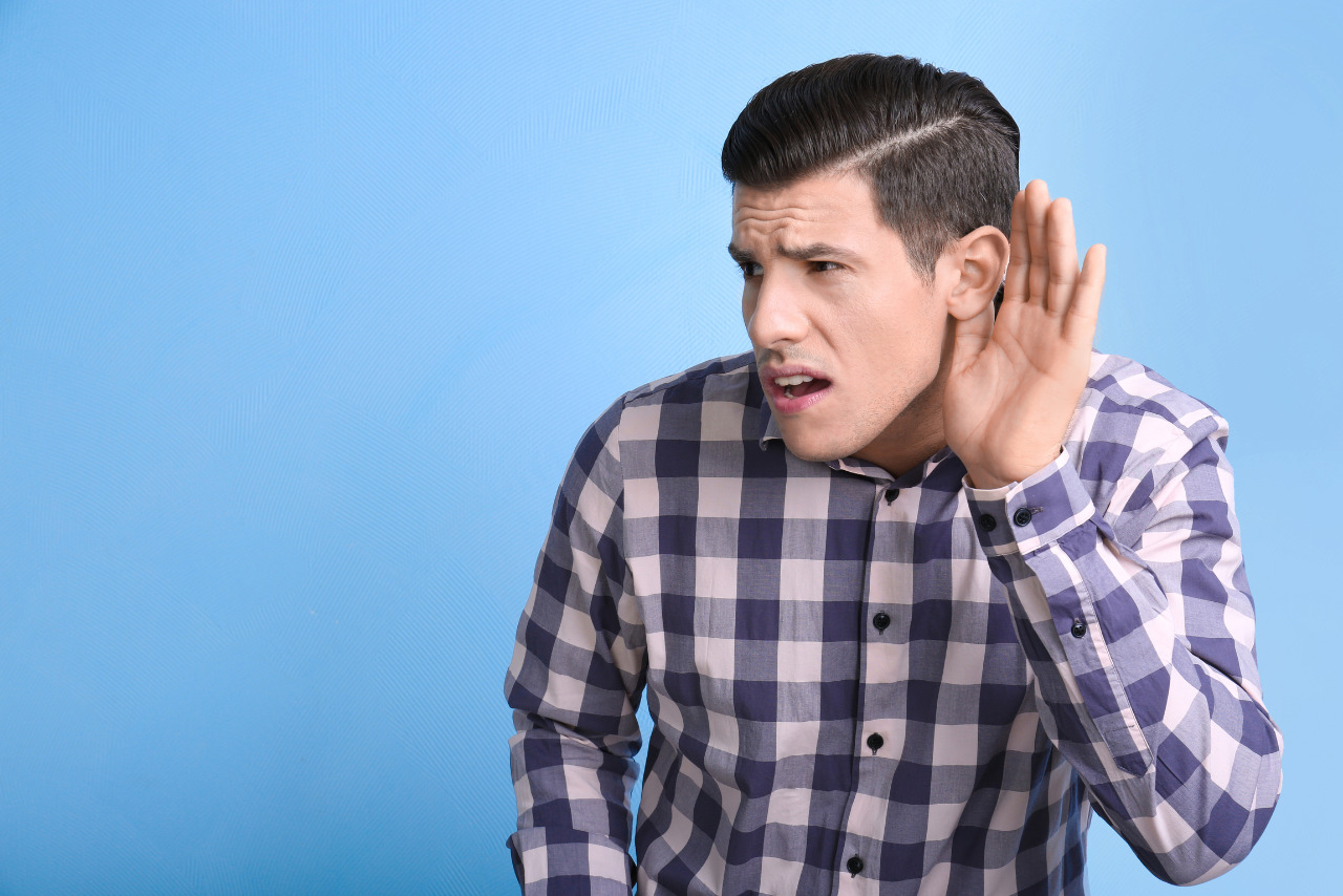Man having difficulties hearing.