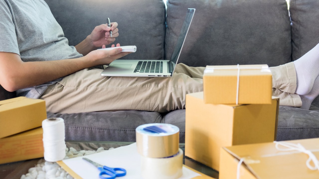 Man lists down online orders and fulfills them.