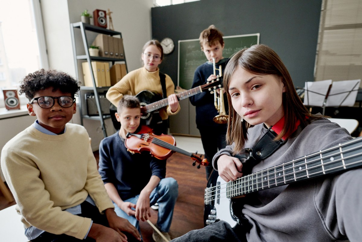 Music students from different race are taking a selfie.