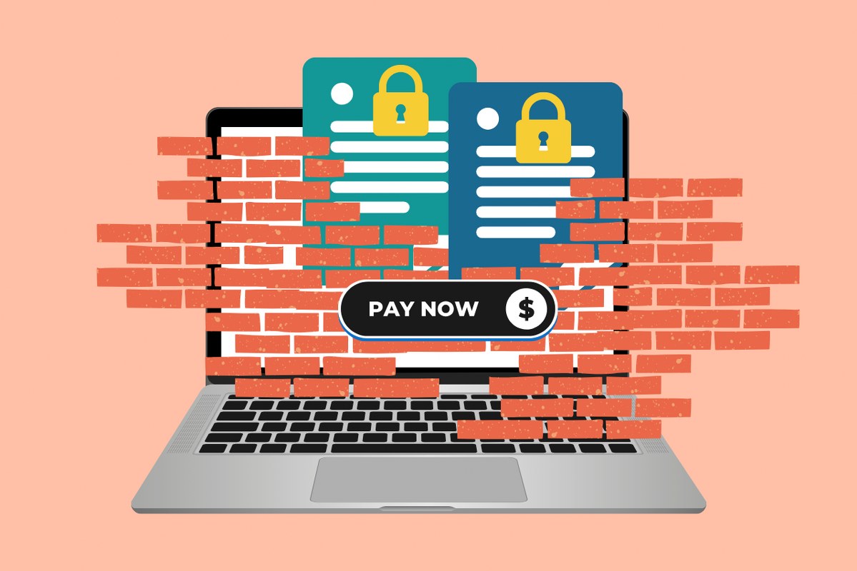 Paywalls concept: Laptop with walled content which can only be read if one sends payment.
