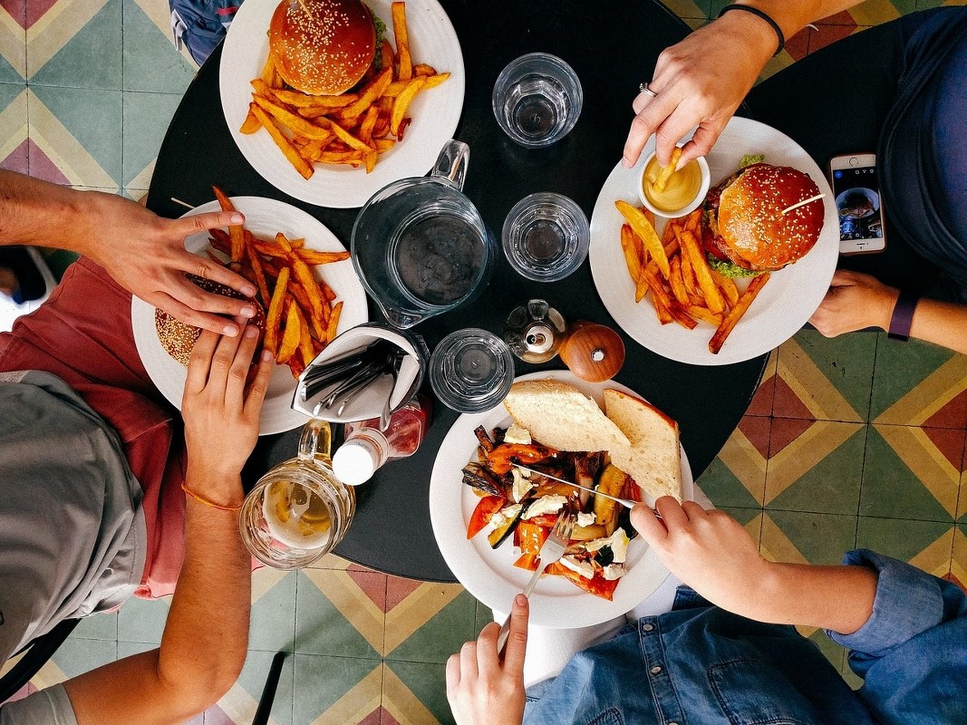 People eating fries and burgers.