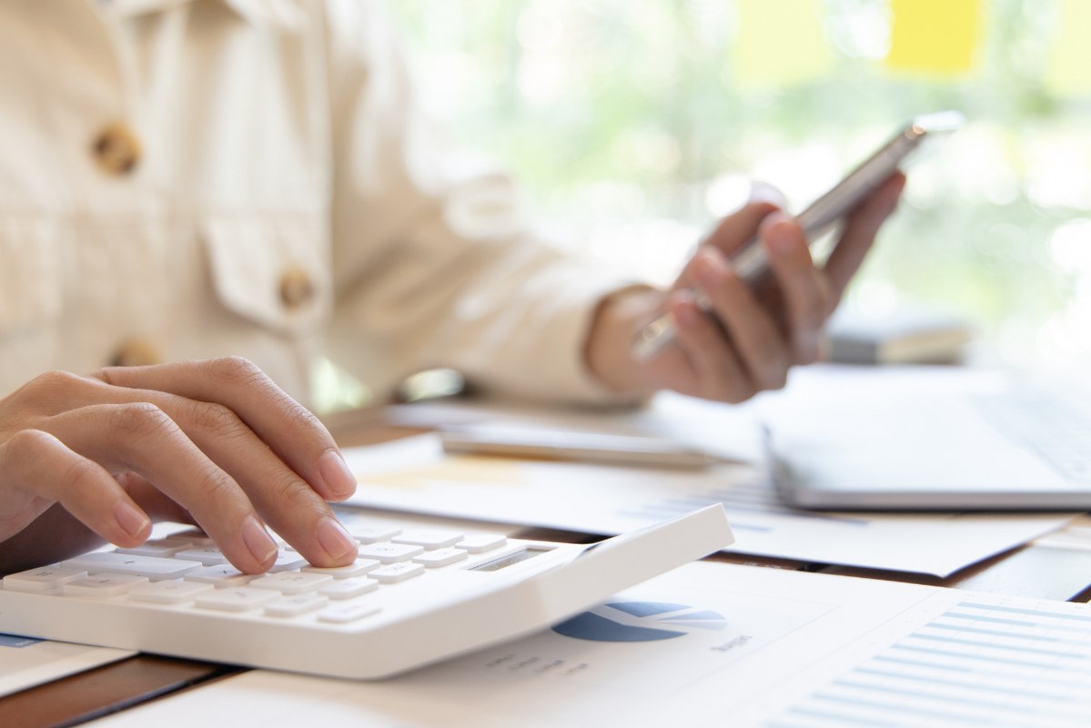 Person Calculating Expenses.