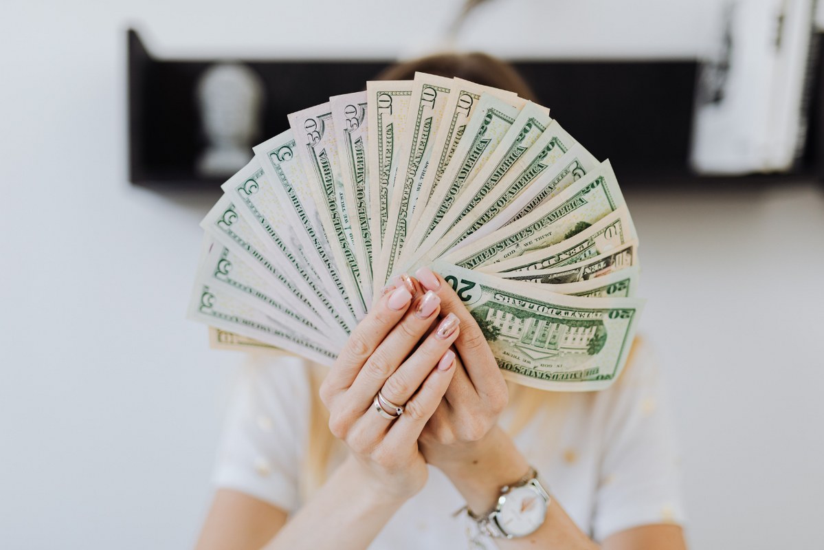 Person Holding Fan of Us Dollar Bills.