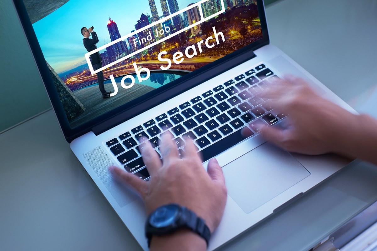 Person Searching for a Job on a Laptop.