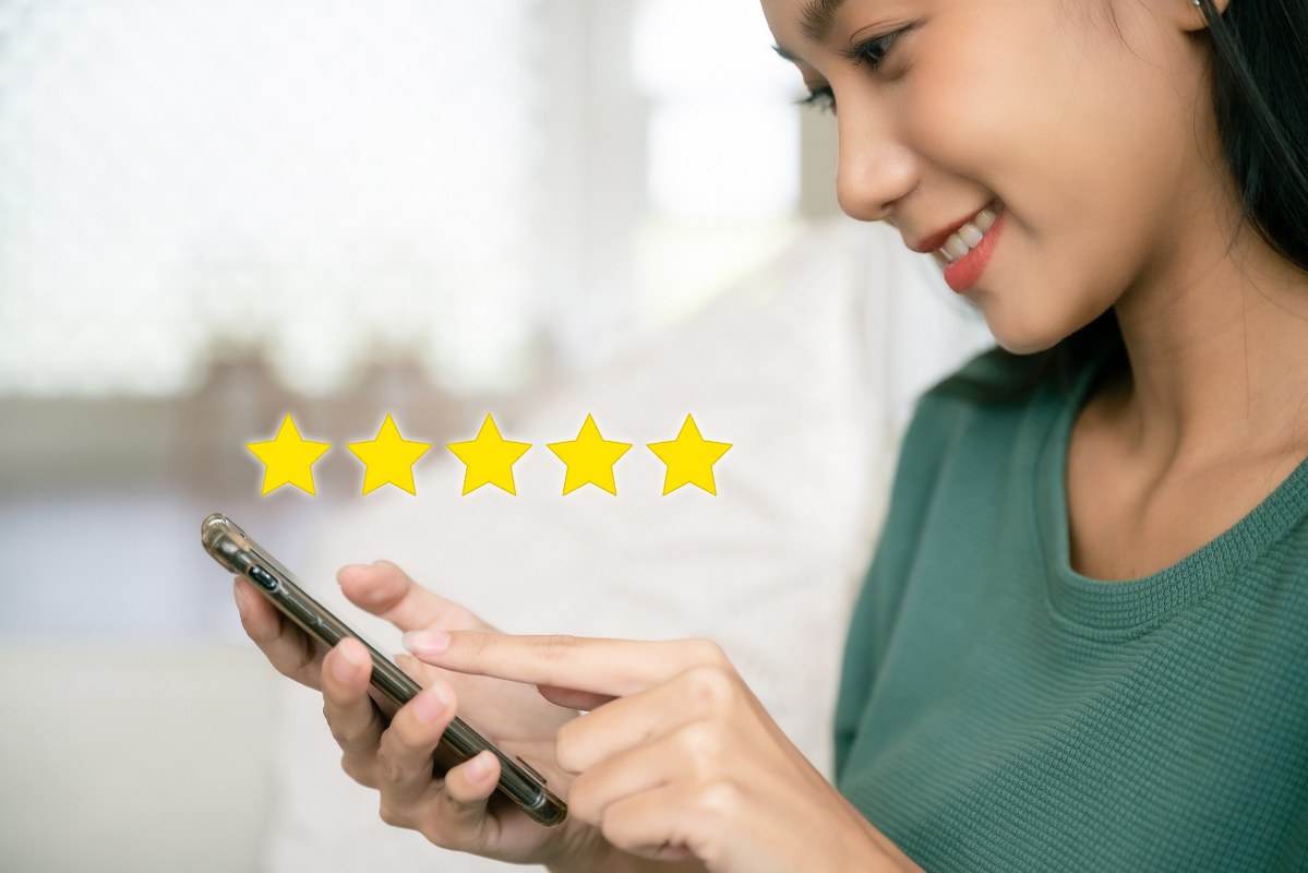 Person on phone rating service five stars.
