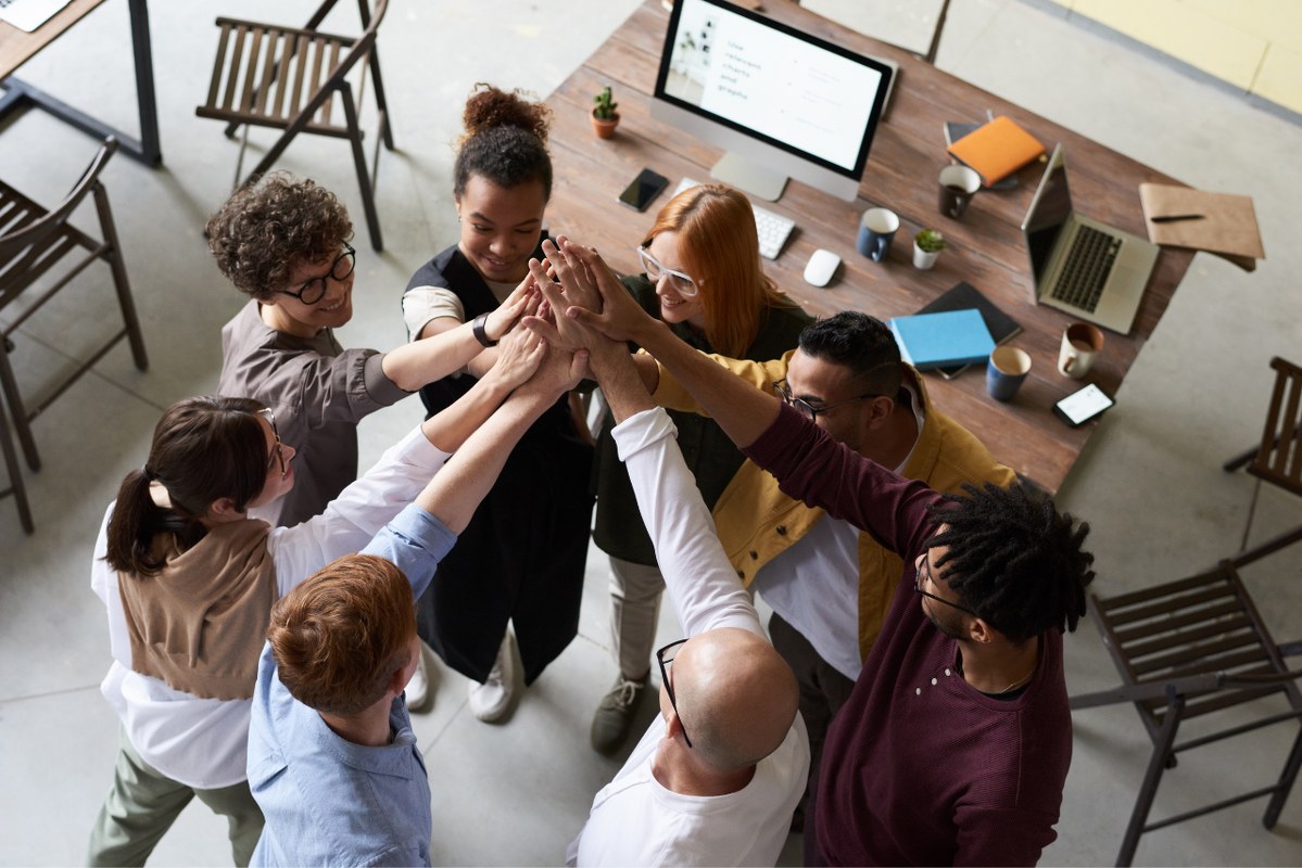 Photo Of People Holding Each Other's Hands signifying collaboration.