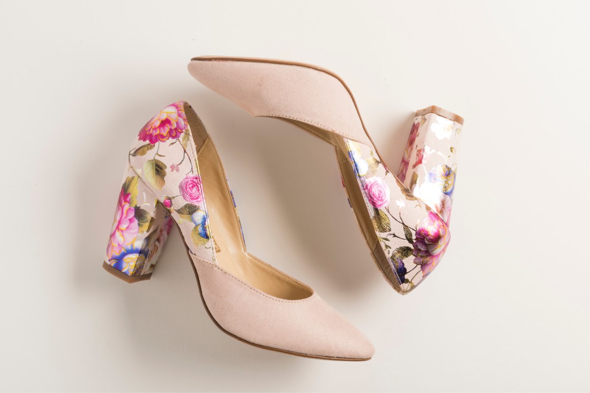 Pink high heel shoe with embroidery.