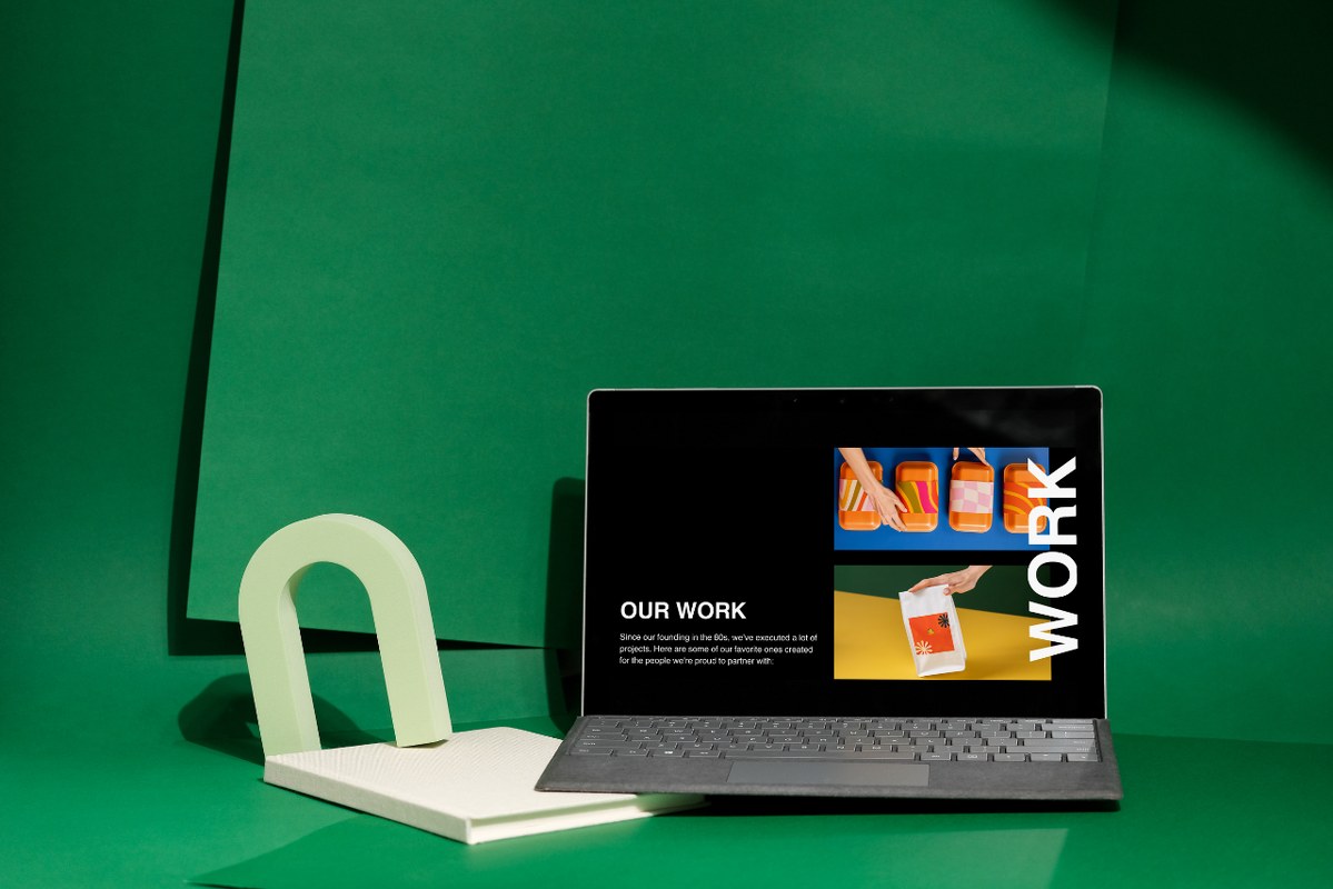 Portfolio page displayed on laptop with green background.