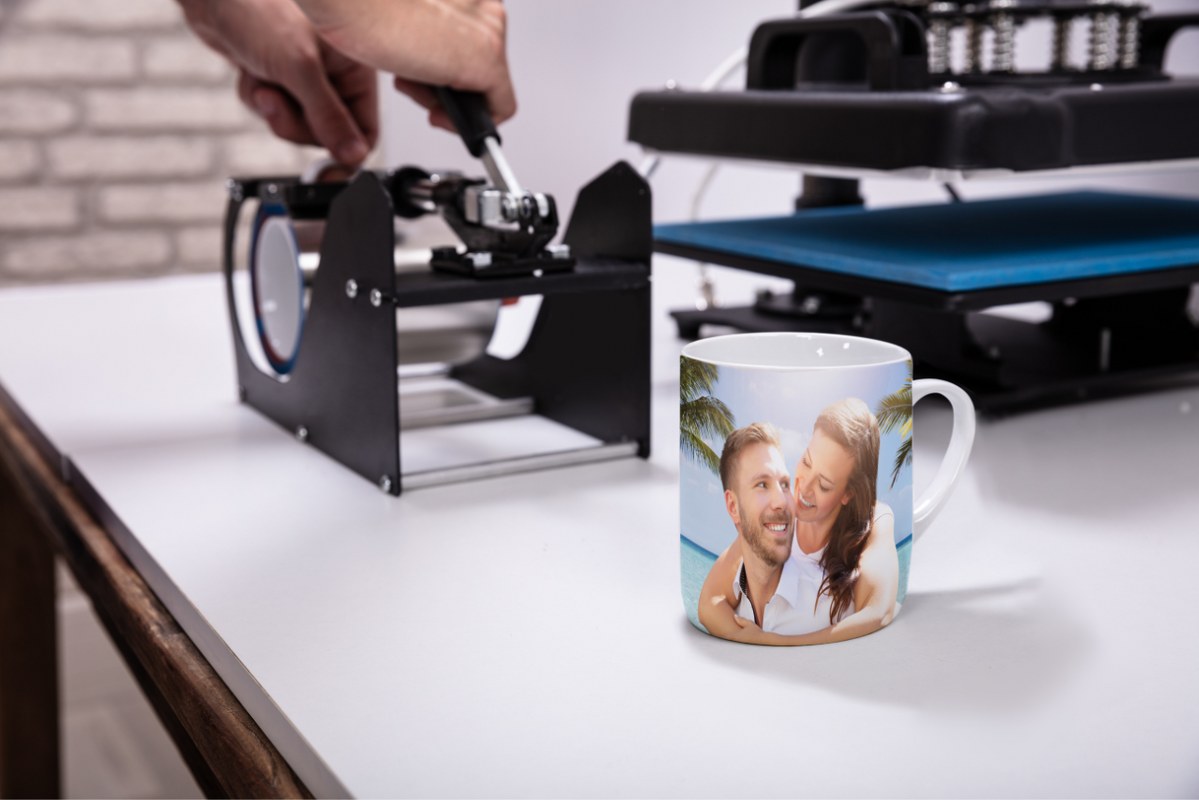 Printing machine and mug on table.