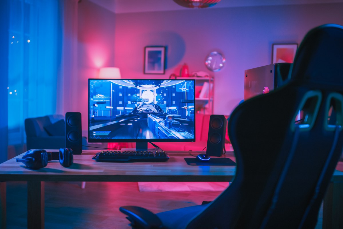 Professional gaming PC setup in neon room.