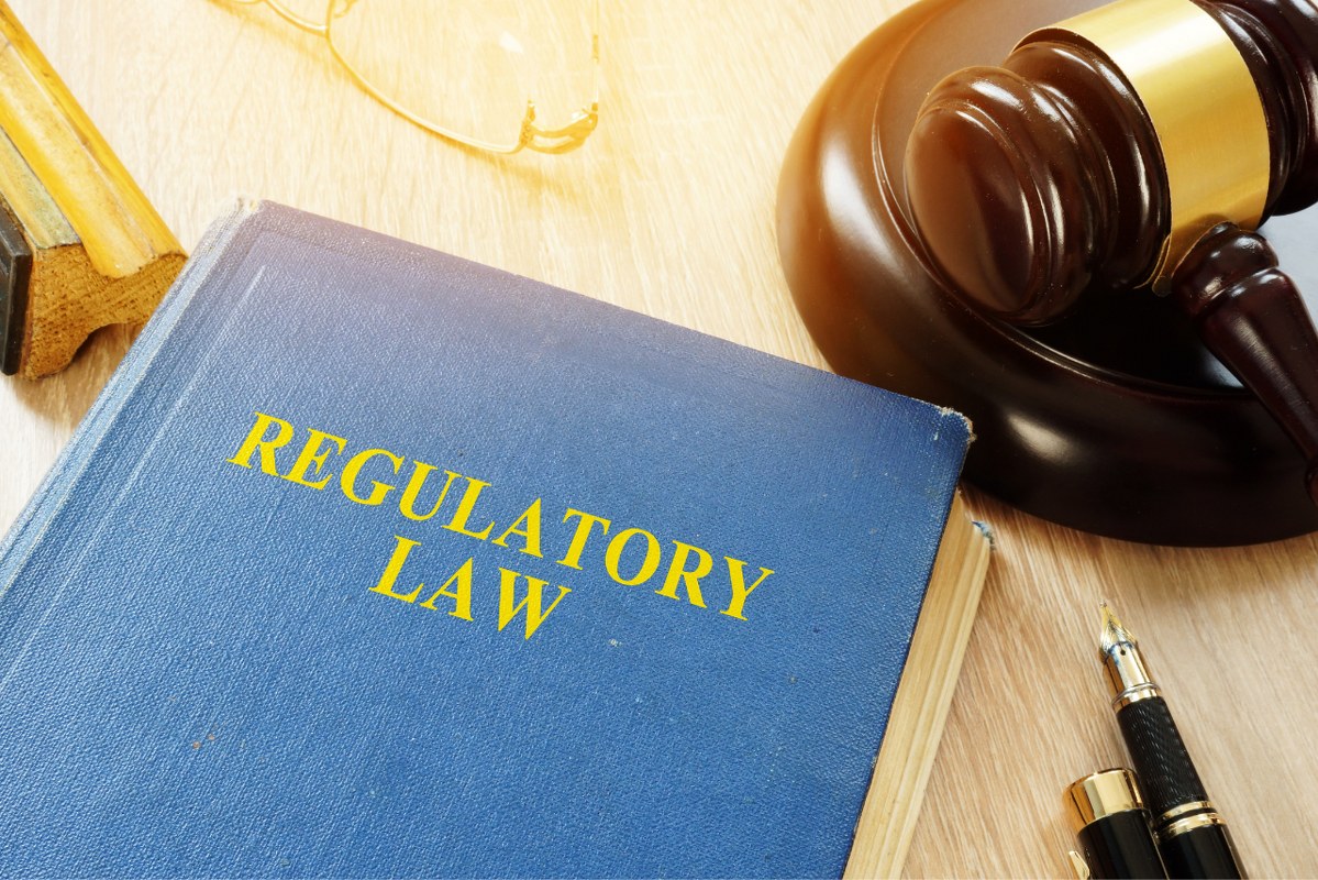 Regulatory law book on desk.