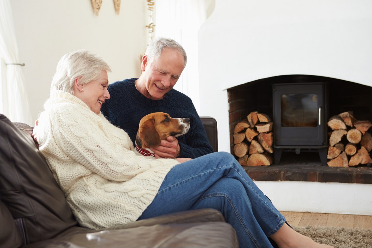 Senior Couple with Pet sitting Dog.