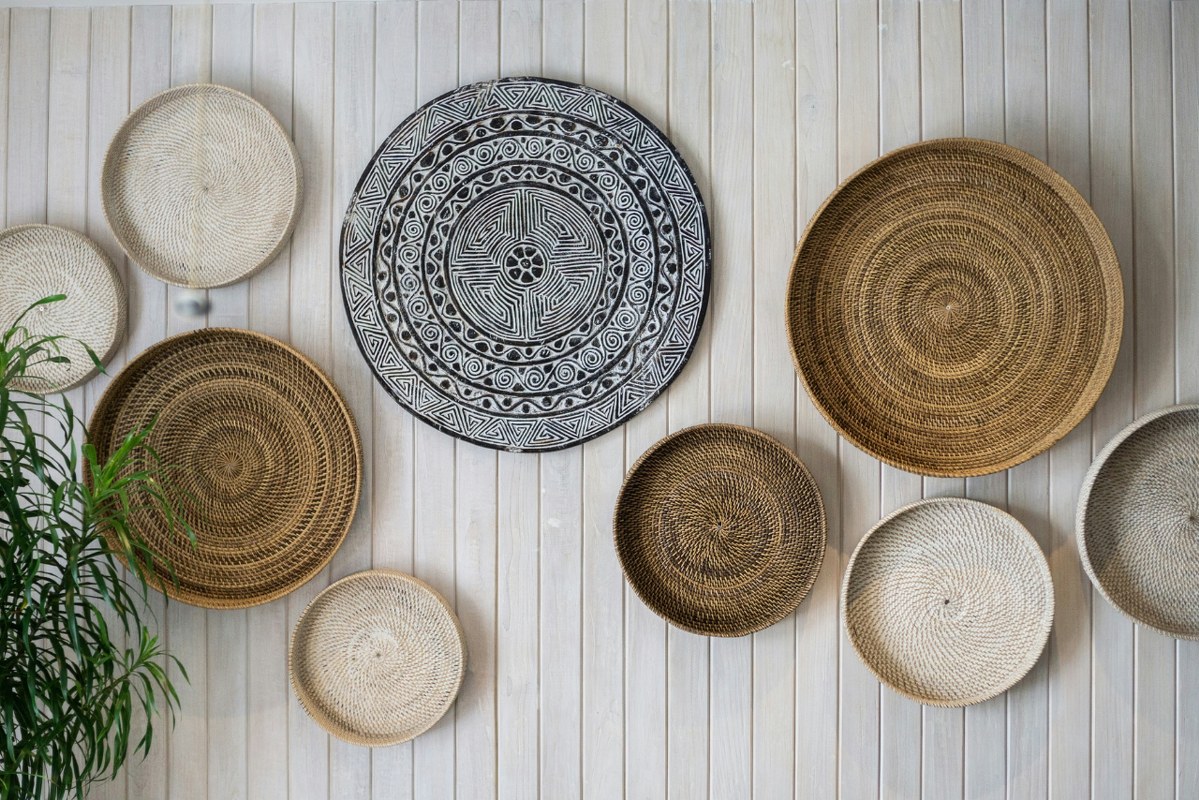 Several pieces of handmade wall decor displayed on the wall.