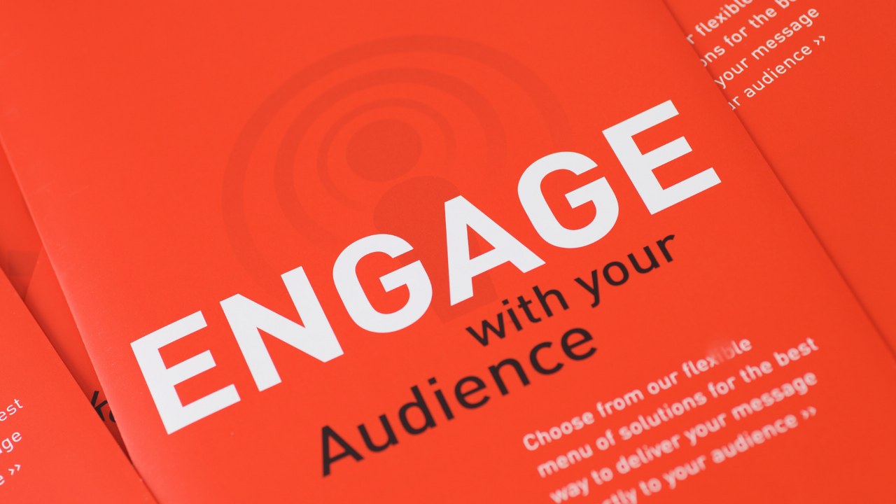 Text on book: Engage with your audience.