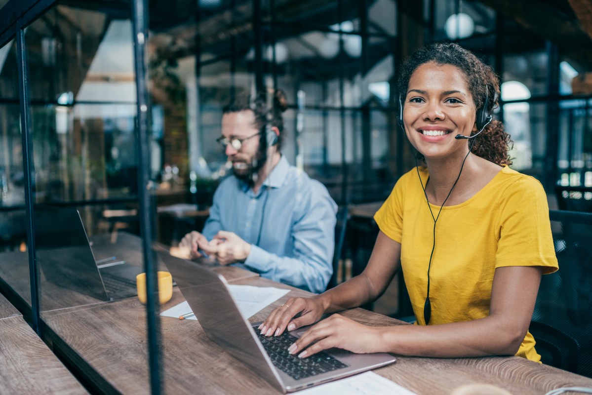 Two customer support people working.