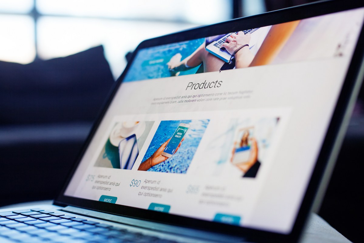 Website displayed on mini laptop.