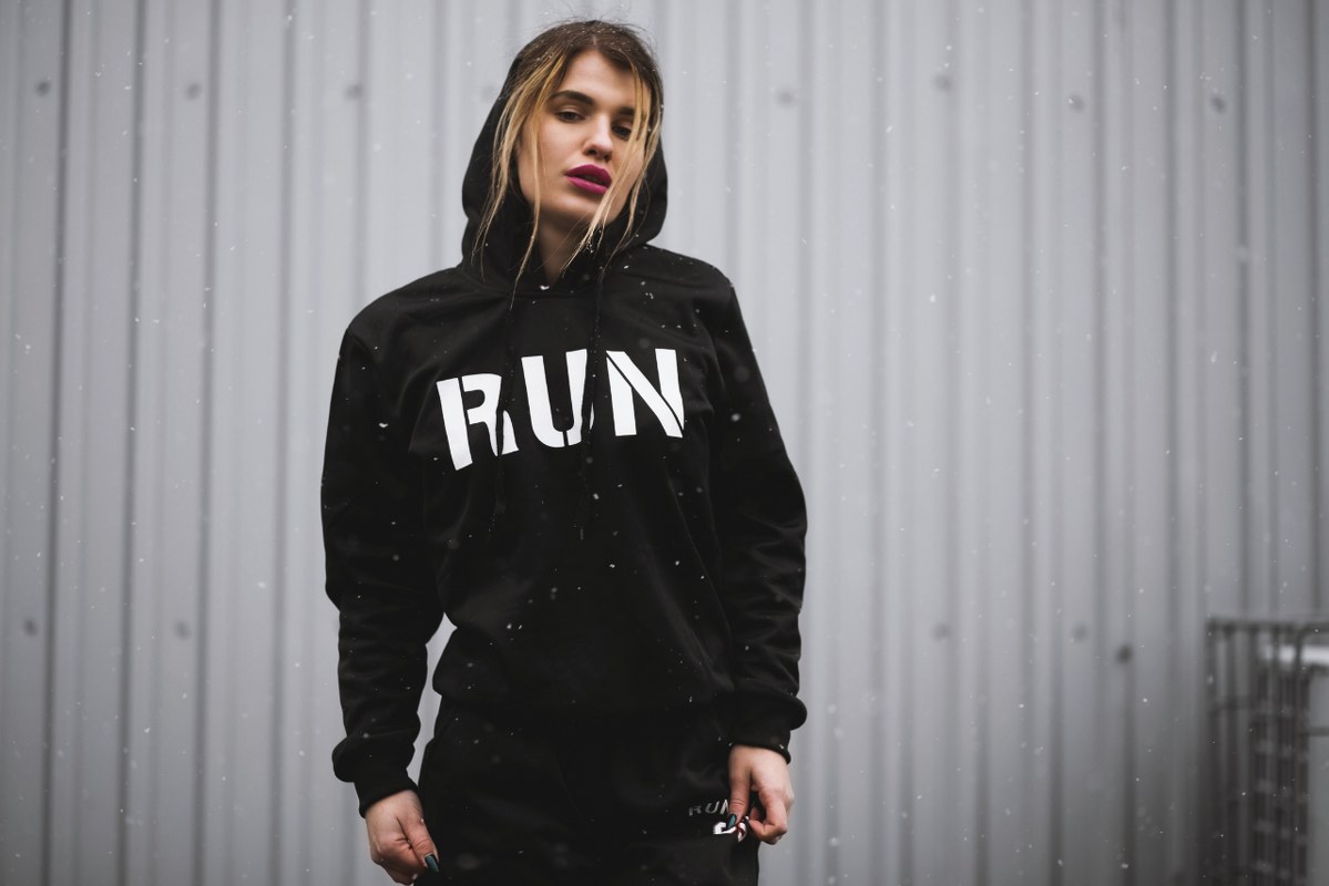 Woman Wearing Black and White Run-embroidered Pullover Hoodie.