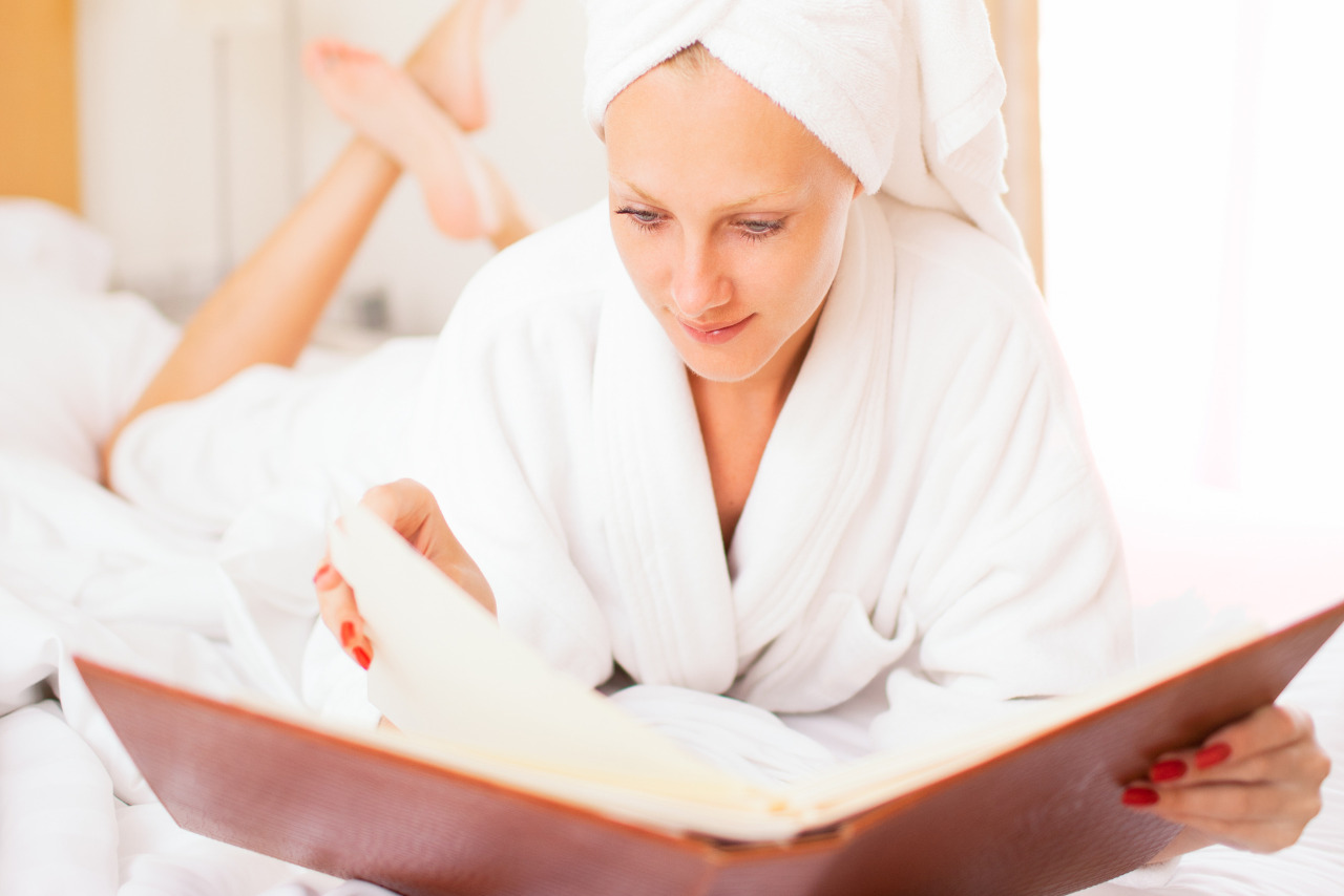 Woman in bathrobe looking at spa services list.