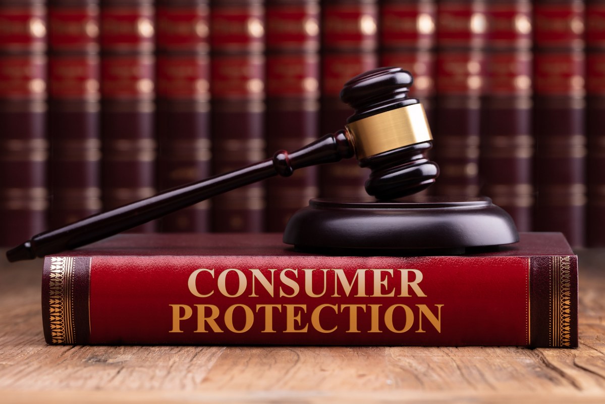 Wooden Gavel And Soundboard On Consumer Protection Law Book.