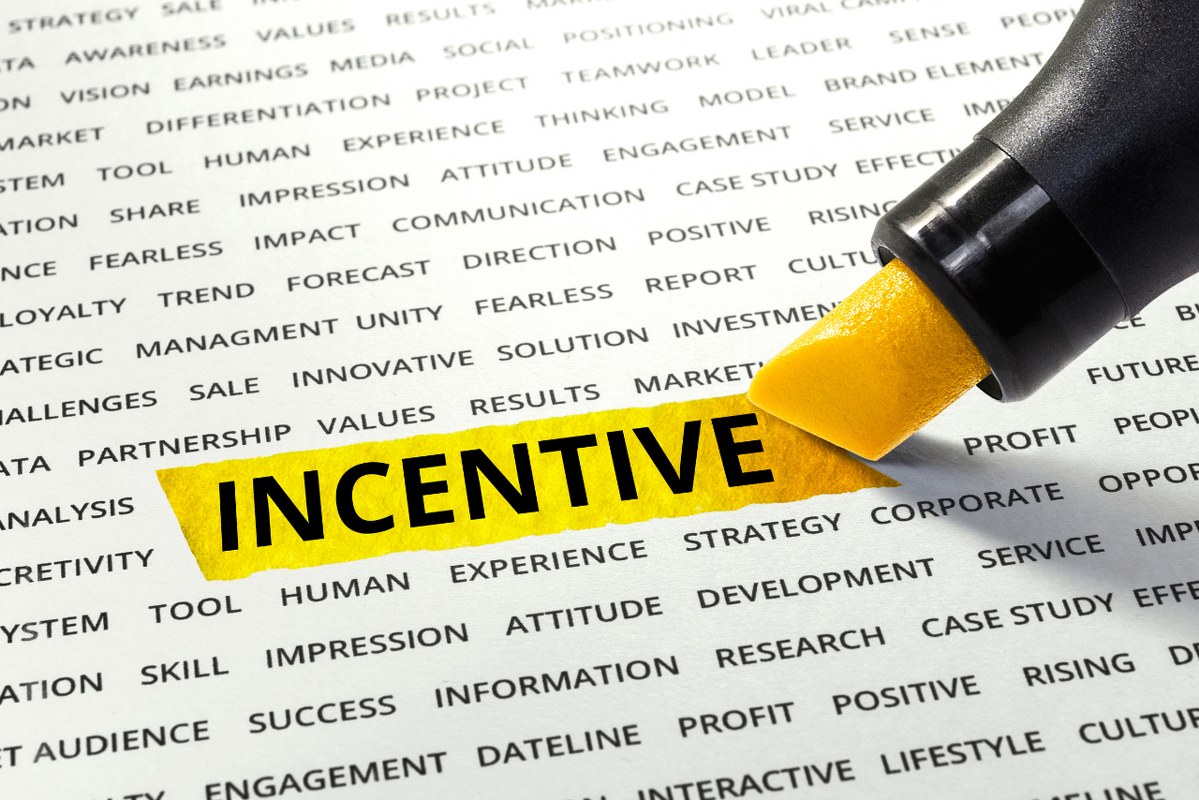 Word Incentive highlighted with yellow marker on paper.