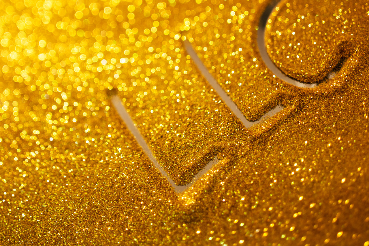 Word LLC writing on golden sand background.