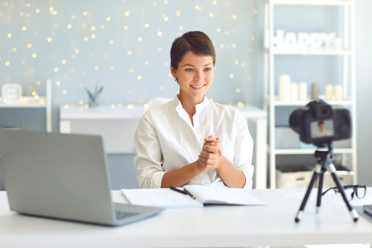Young teacher records herself to create online course.