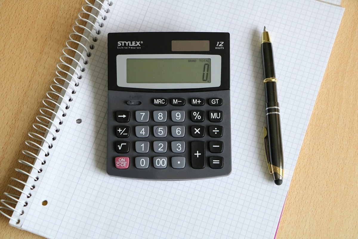 A calculator, a notebook and a pen.