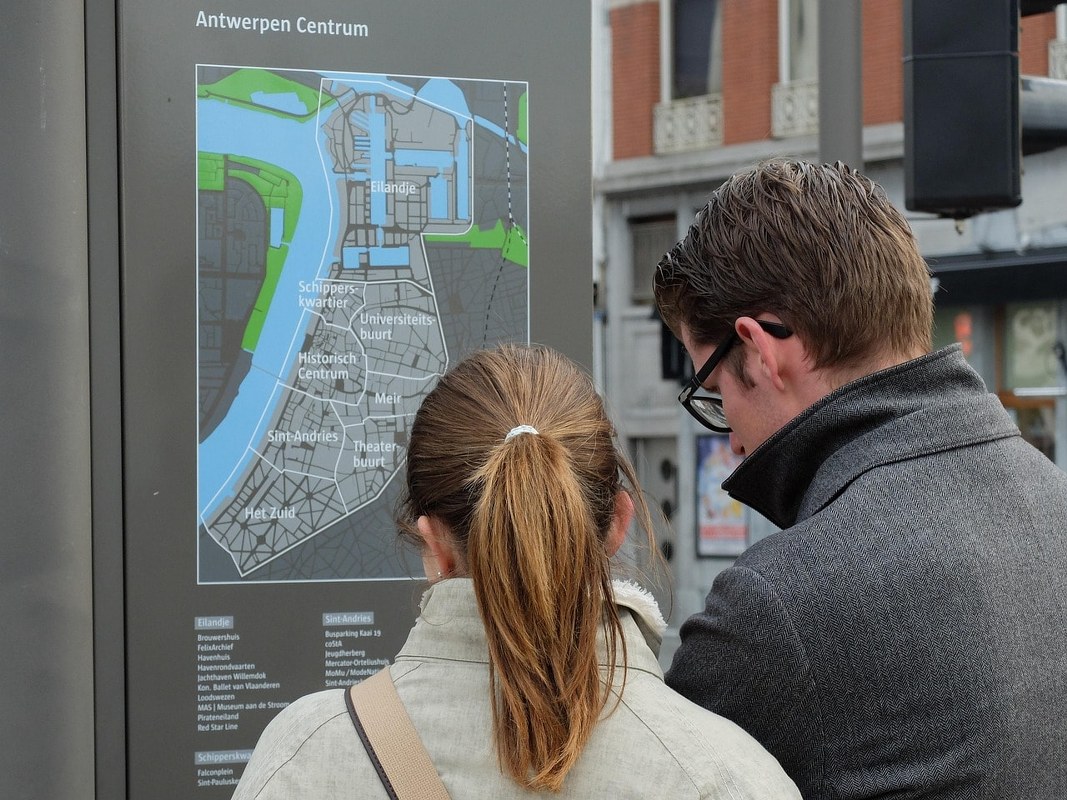 A couple reading a map of a city.