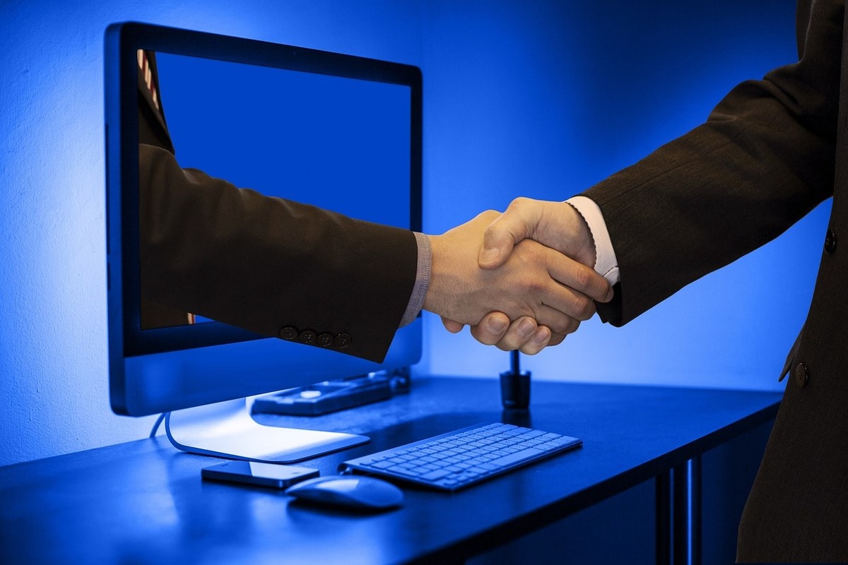 A customer and seller closing a deal with a handshake.