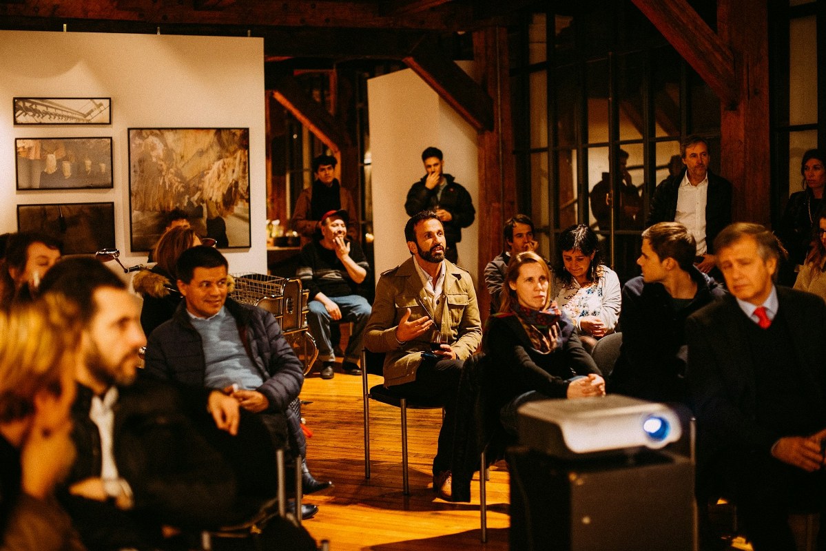 A group of people gathered in an event indoors.