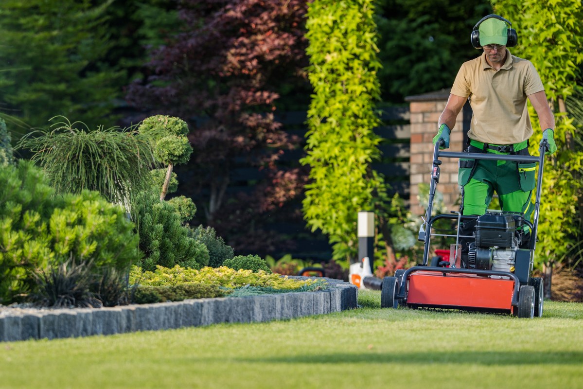 A lawn maintenance professional actively tending to a yard.