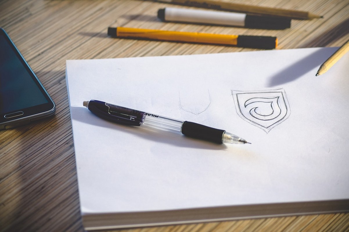 A logo design on paper.