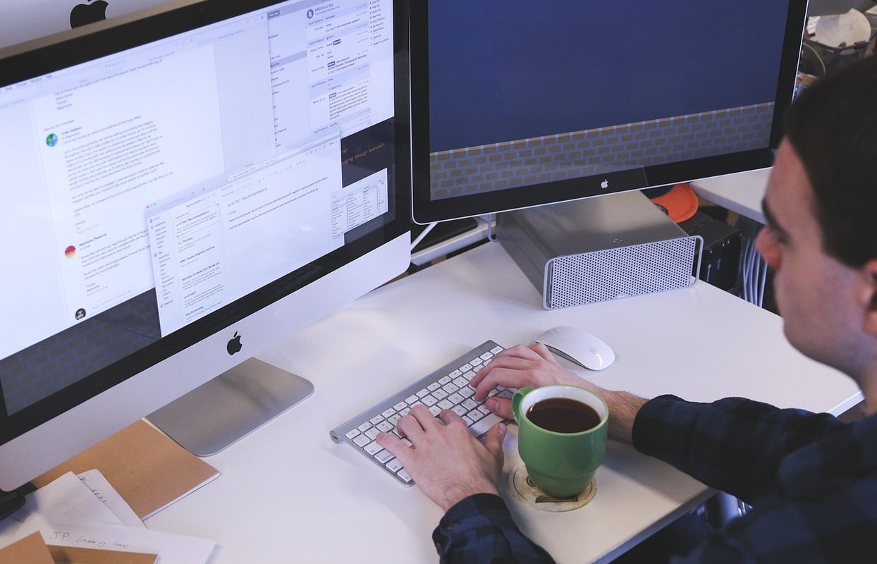 A man editing documents on a computer.