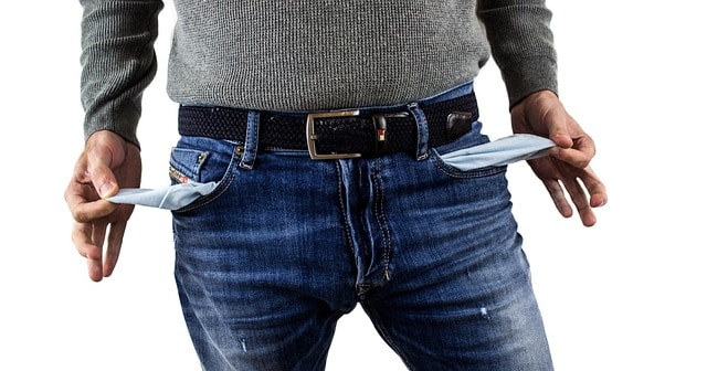 A man is showing empty pockets without money.