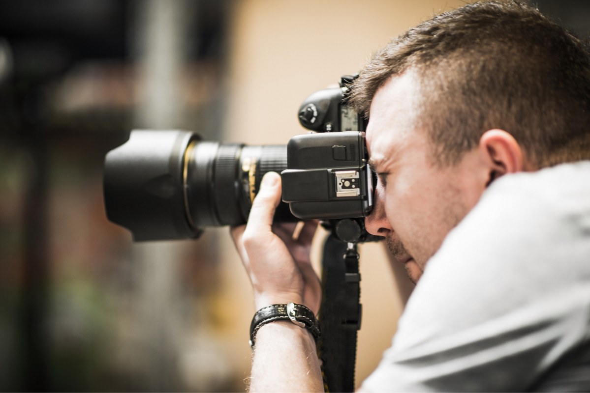 A man is taking a photo with professional camera.