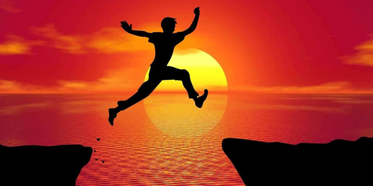 A man jumping over a barrier.