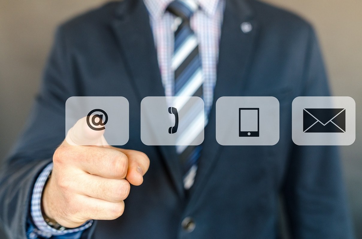 A man pointing at communication channels.