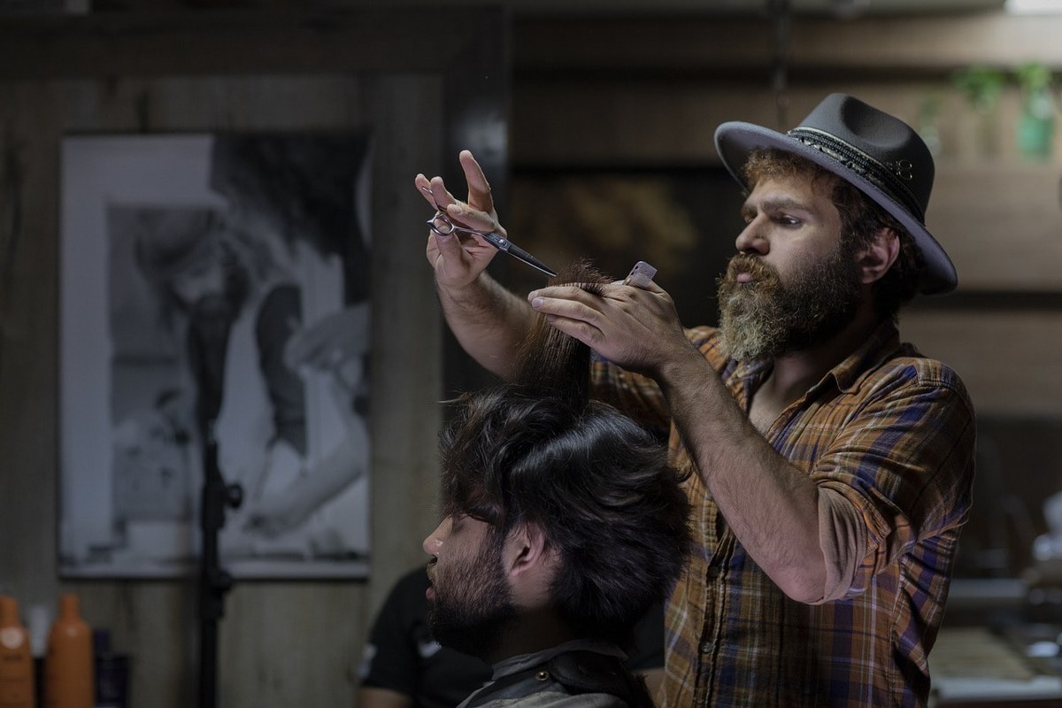 A man shaving in a barber shop.