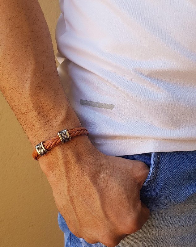 A man wearing a leather bracelet.