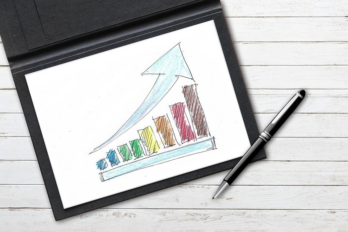 A pen and a hand-drawn graph on a surface.