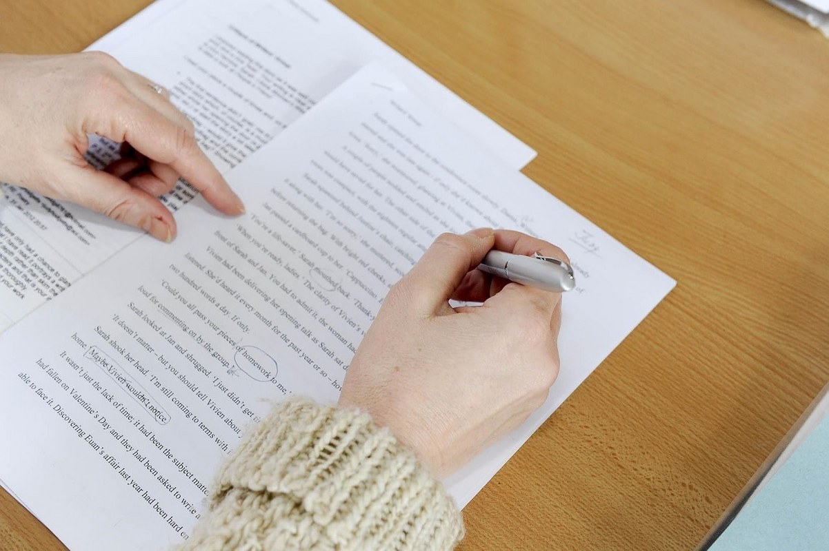 A person going through text in a document.