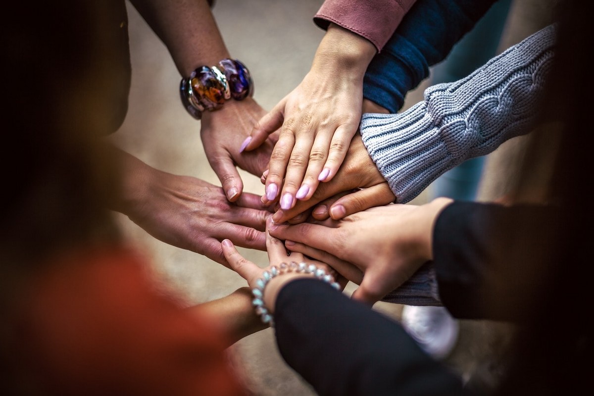 A team holding their hands together.