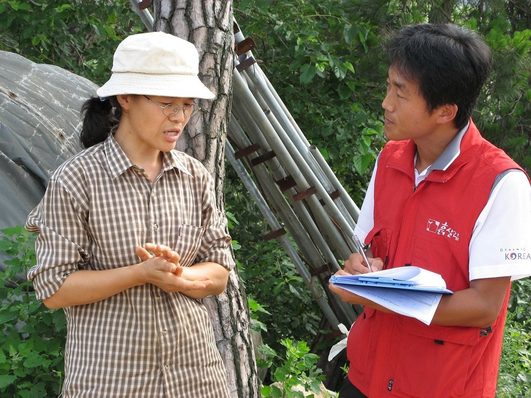 A woman being questioned by a government official in the process of obtaining a license to practice.