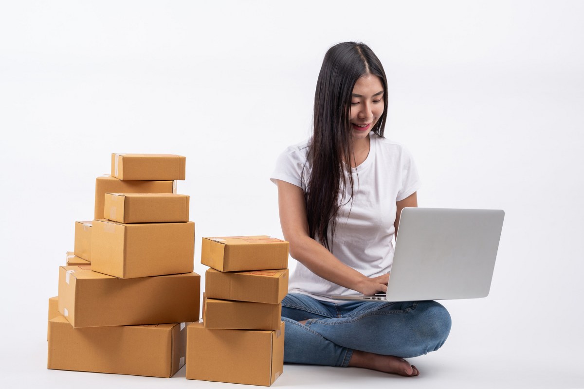 A woman handling shipment boxes.
