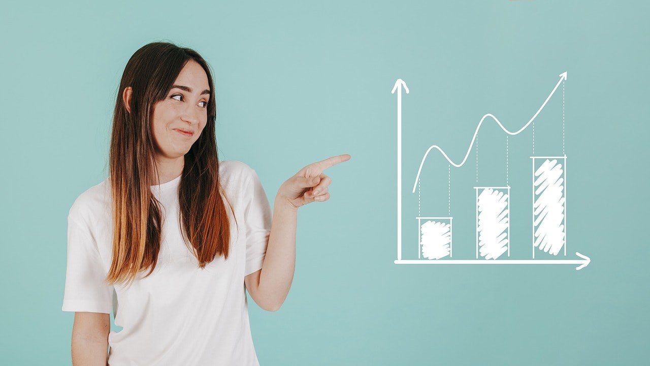 A woman pointing at a growth graph.