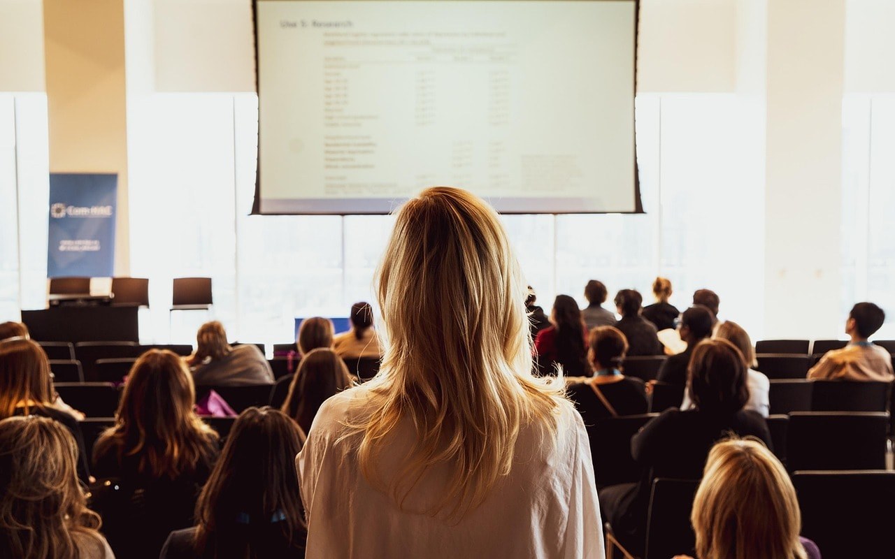 A woman speaking in a conference.