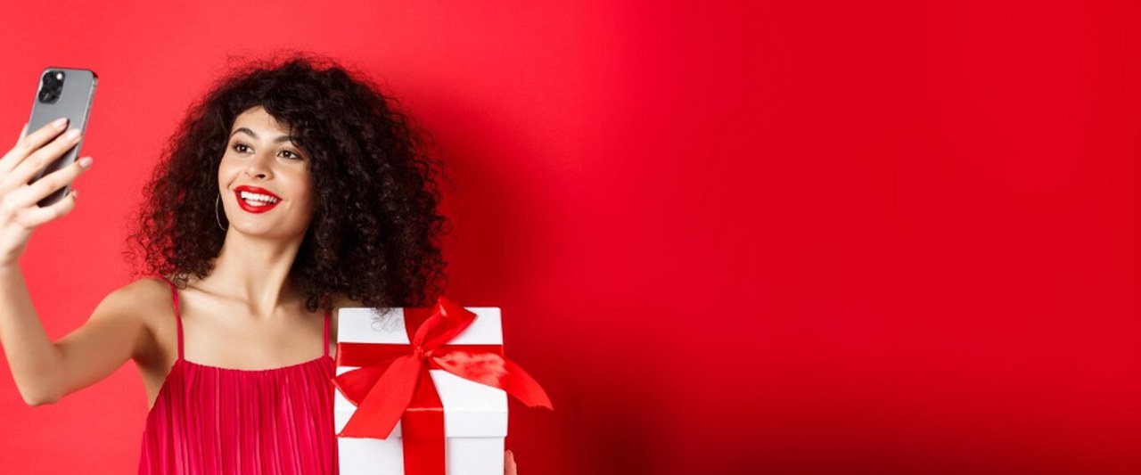 A woman taking a photo with a Valentine's day gift.