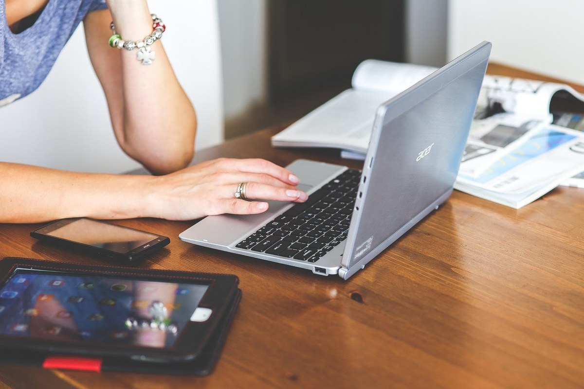 A woman typing on a laptop.