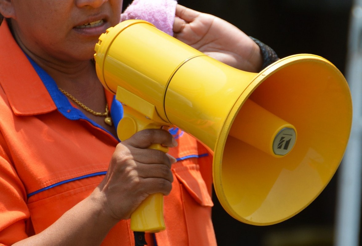 A woman using a megaphone.